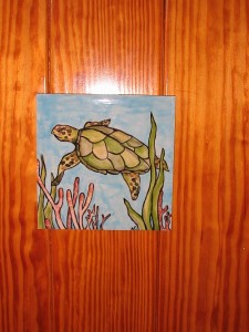 Each stateroom has a hand painted tile on the cabin door.