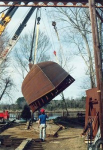 Using 2 cranes to flip the hull over and set Ciganka on her keel